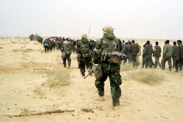 U.S. Marines with Iraqi POWs during Iraqi War, 2003