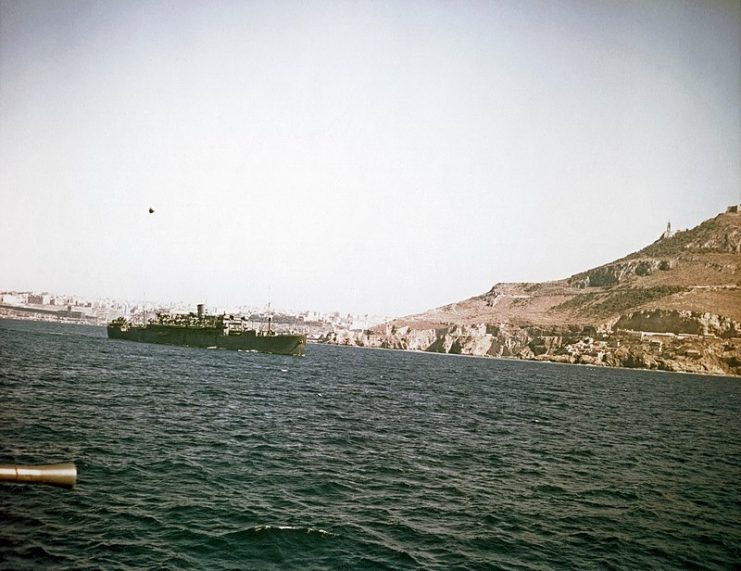 British Landing Ship Infantry (Large). Steaming toward Mers-el-Kebir harbor, Algeria, circa July 1943. The city of Oran is in the left distance. This is one of several large amphibious transports converted from commercial passenger liners for use by the Royal Navy. It appears to be streaming a barrage balloon.