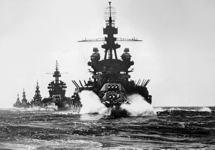 The U.S. Navy battleship USS Pennsylvania (BB-38) leading USS Colorado (BB-45) and the cruisers USS Louisville (CA-28), USS Portland (CA-33), and USS Columbia (CL-56) into Lingayen Gulf, Philippines, in January 1945.