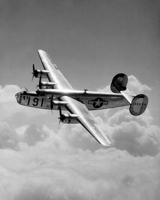 A Consolidated B-24 Liberator from Maxwell Field, Alabama, four engine pilot school, glistens in the sun as it makes a turn at high altitude in the clouds.