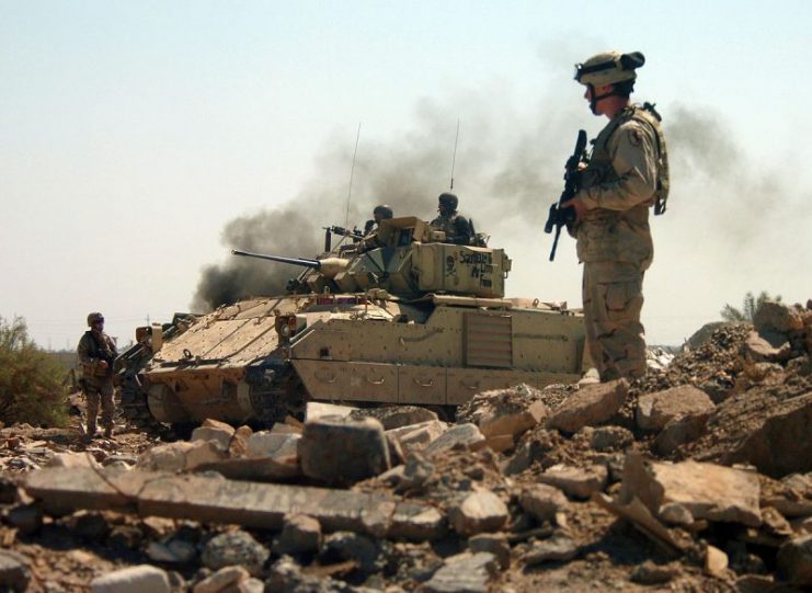 U.S. Army Soldiers assigned to the 2nd/11th Armored Cavalry Regiment (ACR) cautiously advance into a bunker area as they conduct a raid on the Hateen Weapons Complex in Babil, Iraq, 2005