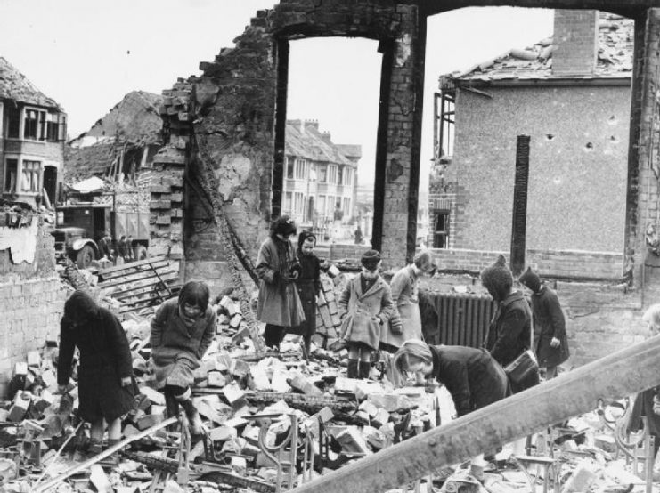 Children searching for books among the ruins of their school in Coventry after a night raid, 10 April 1941.