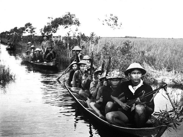 Guerrilla forces from North Vietnam’s Vietcong movement cross a river in 1966 during the Vietnam War