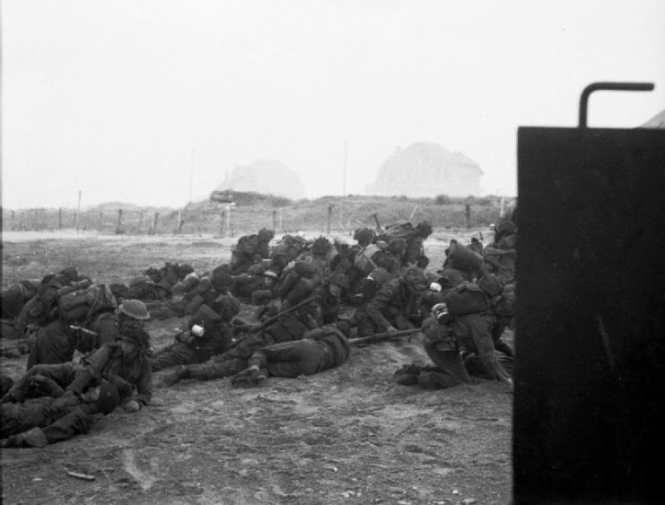 Infantry waiting to move off ‘Queen White’ Beach