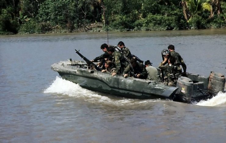 Members of U.S. Navy Seal Team One move down the Bassac River in a Seal Team Assault Boat (STAB) during operations along the river south of Saigon, 11/1967.