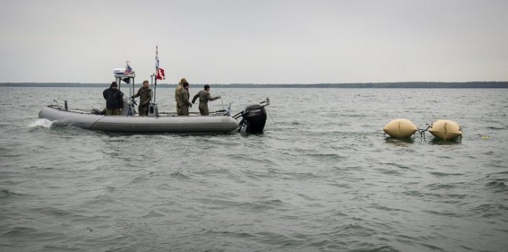 Members of Explosive Ordnance Disposal Mobile Unit (EODMU) 8, along with Estonia Explosive Ordnance Disposal team members, deploy enclosed flotation bags in order to tow a World War II-era German Bottom-Mine (LMB) as part of mine countermeasure operations in the Baltic Sea off the coast of Estonia, May 26, 2015, during Exercise Open Spirit. Photo: U.S. Navy photo by Mass Communication Specialist 2nd Class Patrick A. Ratcliff/Released