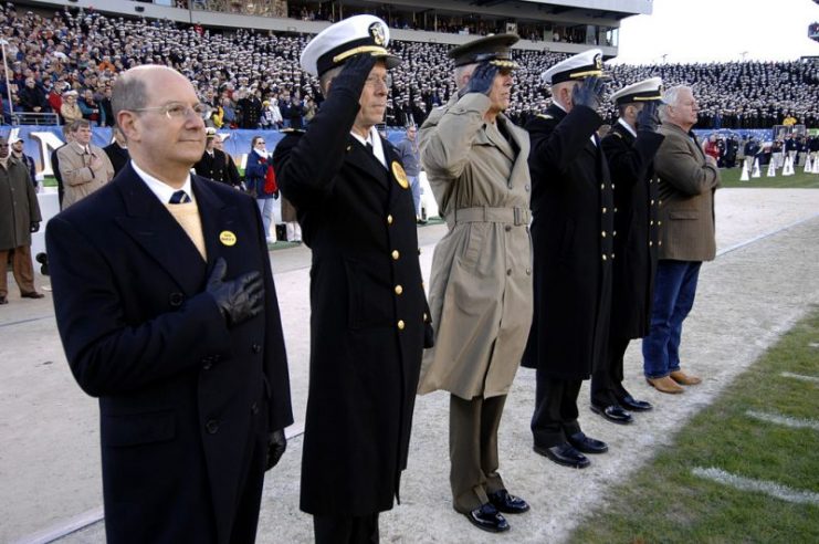 Retired Navy SEAL and Medal of Honor recipient Robert E. Thornton (far right), renders honors at the playing of the National Anthem during opening ceremonies for the 107th playing of the Army vs. Navy football game.