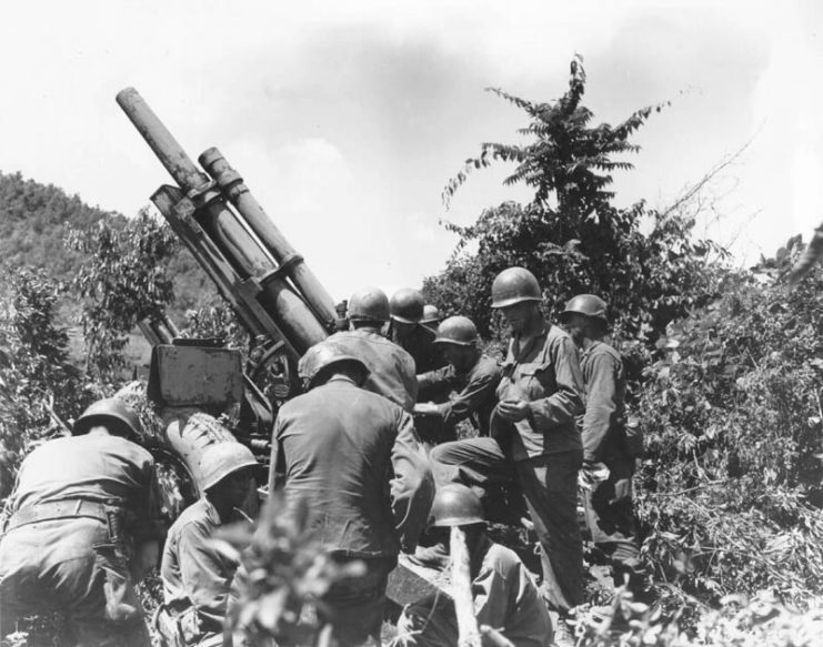Korean War: A gun crew checks their equipment near the Kum River. 15 July 1950. Korea.