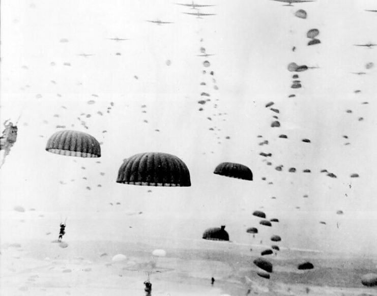 ‘Parachutes open overhead as waves of paratroops land in Holland during operations by the 1st Allied Airborne Army. September 1944