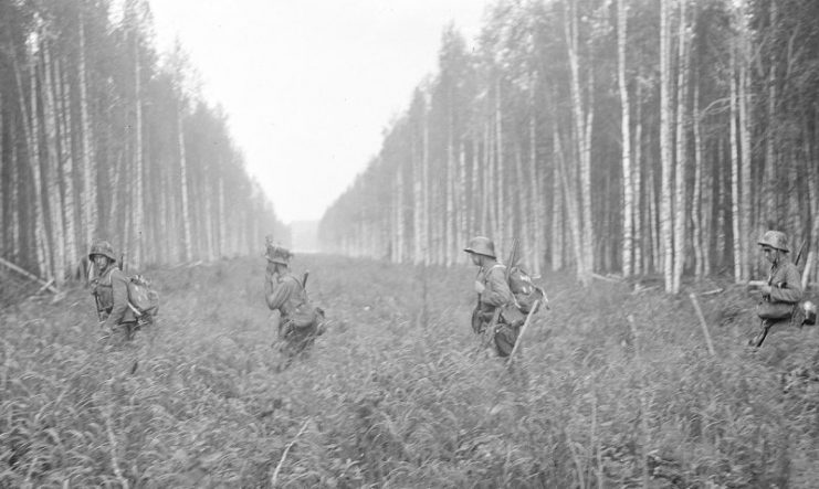 Finnish soldiers crossing the 1940-agreed border  at Tohmajärvi on 12 July 1941, two days after the invasion started