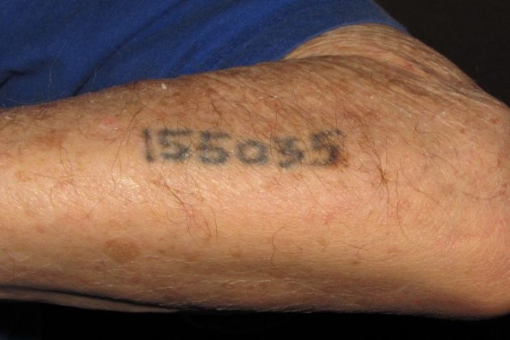 Auschwitz survivor displays tattoo Photo by Jacek Proszyk CC BY SA 4.0