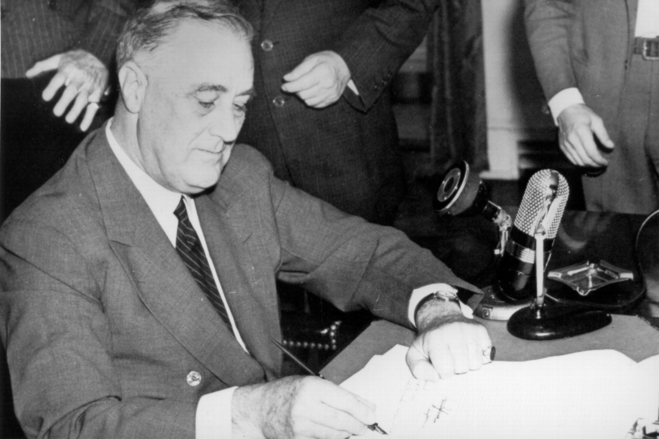 President Franklin D. Roosevelt signs the Selective Training and Service Act.
