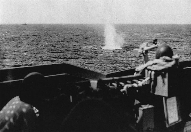 A German shell explodes near the U.S. Navy heavy cruiser USS Quincy (CA-71) during the invasion of Southern France, in August 1944.