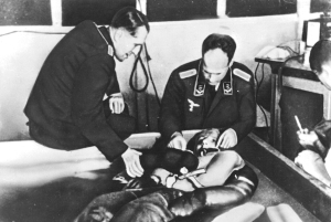 A cold water immersion experiment at Dachau concentration camp presided over by Ernst Holzlöhner (left) and Sigmund Rascher.