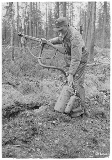 A Finnish soldier with a captured Soviet ROKS-3 flamethrower, June 1943. Note the flame projector has been designed to resemble a standard infantry rifle