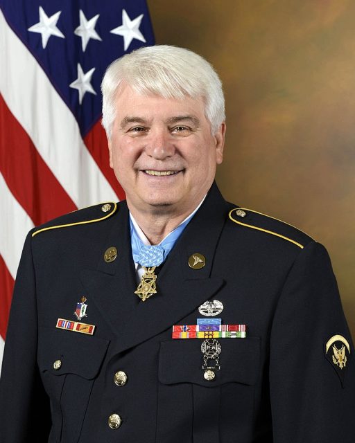 James C. McCloughan, the recipient of the Medal of Honor, poses for a portrait with the medal in the Army portrait studio at the Pentagon in Arlington, Va., Aug. 1, 2017. (U.S. Army photo by Monica King)