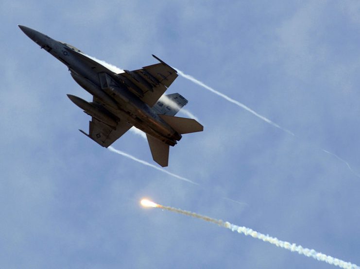 A VFA-11 F A-18F Super Hornet performing evasive maneuvers during an air power demonstration