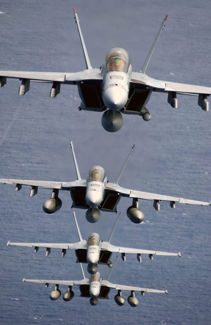 Four F A-18Fs of VFA-41 “Black Aces” in a trail formation. The first and third aircraft have AN ASQ-228 ATFLIR pods, and the last aircraft has a buddy store tank