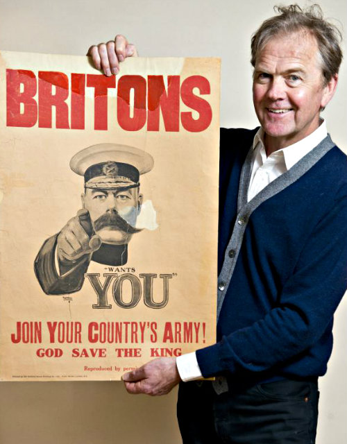 The auctioned Lord Kitchener poster with the auctioneer.