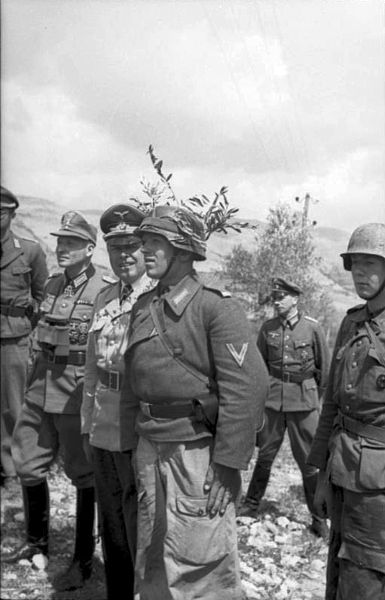 Fieldmarshal Albert Kesselring visits the front at Cassino and talks to an artillery officer who is in charge of providing indirect fire.