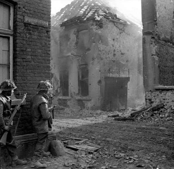 Men of the 1st Royal Norfolks, 3rd Division, clearing enemy resistance in Kervenheim, Germany, 3 March 1945. 