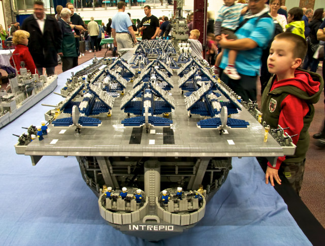 USS Intrepid (by Ann Diment, Ed Diment, Ralph Savelsberg) USS Intrepid is a US Navy aircraft carrier that served from World War 2 until 1974 and is now a museum in New York. This Lego model of the ship is to the scale of Minifigs (Lego people). It is nearly 7m long, weighs 250kg, needed 250,000 bricks to build and took three people (with a number of other helpers) over 9 months to build