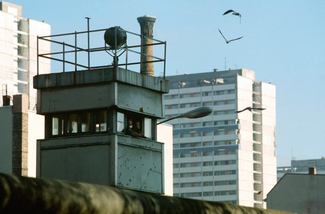 East German guards feed the birds from their post at the Berlin Wall near Checkpoint Charlie.