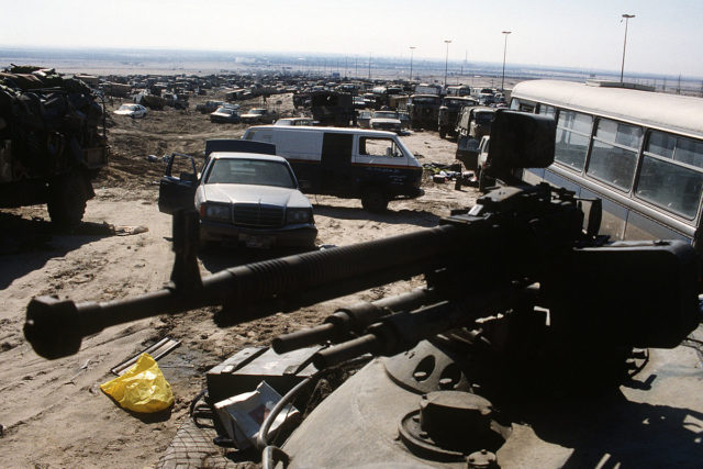 Abandoned vehicles clog the Basra-Kuwait highway out of Kuwait City after the retreat of Iraqi forces. A view from top of an Iraqi tank on February 26, 1991. The car in the centre is a Mercedes-Benz W126 S-class.