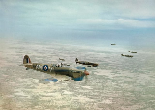 Royal Canadian Air Force Spitfires flying over the Tunisian desert, 1943. © IWM (TR 865)