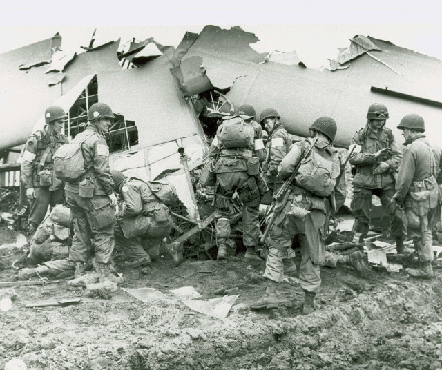 (101st Airborne in front of a crashed glider, c. 1944)