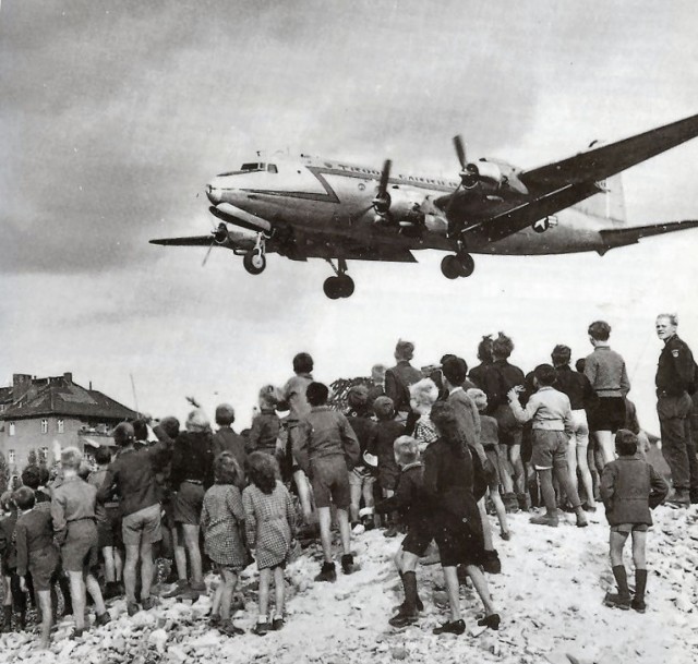 Berliners watch a Douglas C-54 Skymaster land at Tempelhof Airport, 1946