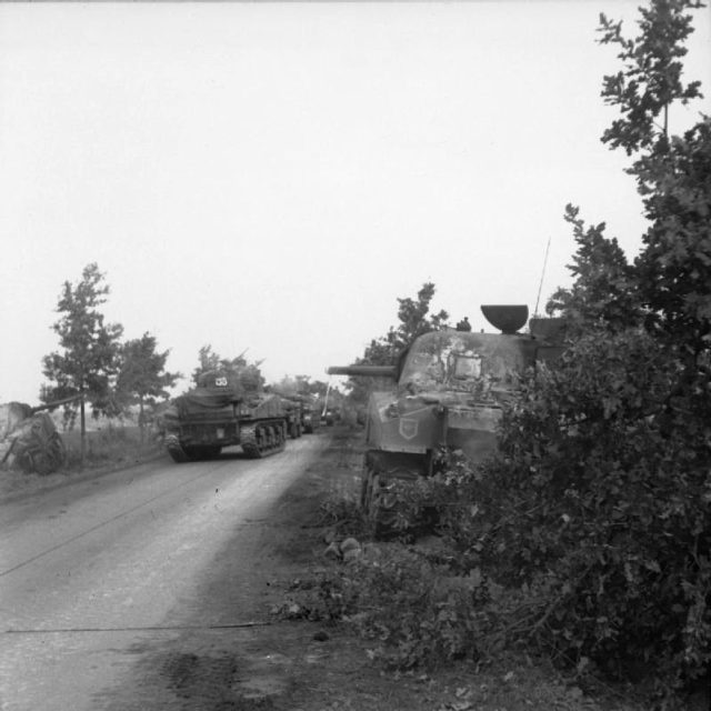 Irish Guards Sherman tanks advance past previously destroyed ones in the initial stage of Operation Market Garden on 17 September 1944.