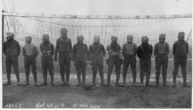 Football team of British soldiers with gas masks, Western front, 1916.