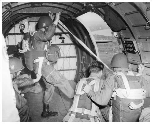 Airborne paratroopers jump from a C-47 in a training exercise. A year of intense training could not fully prepare these soldiers for what they would see in Normandy. (Courtesy of U.S. National Archives)