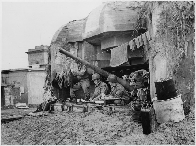 Allied Soldiers Do Laundry in Captured German Pillbox (Image).