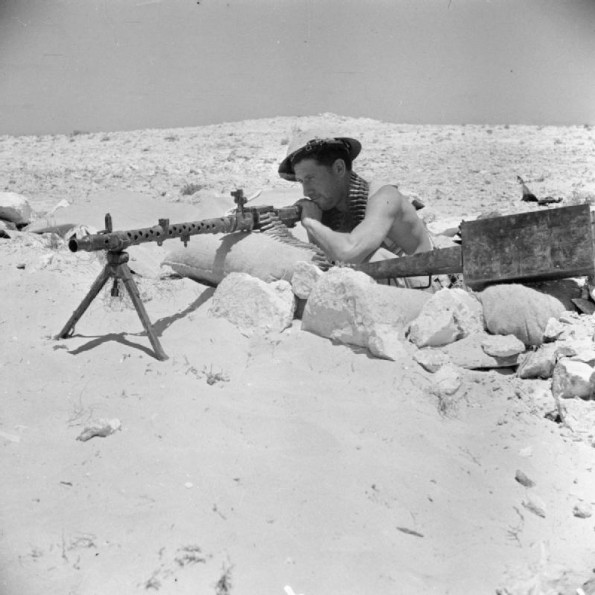 An Australian soldier with a captured German MG 34 machine gun. 25 July 1942