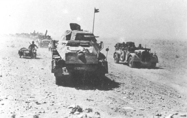 Afrika Korps tank hunters with an Sd.Kfz. 232 armoured car in front [via]