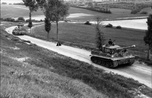 Wittmann's company, 7 June 1944, on Route nationale 316, en route to Morgny. Wittmann is standing in the turret of Tiger 205 (Image).