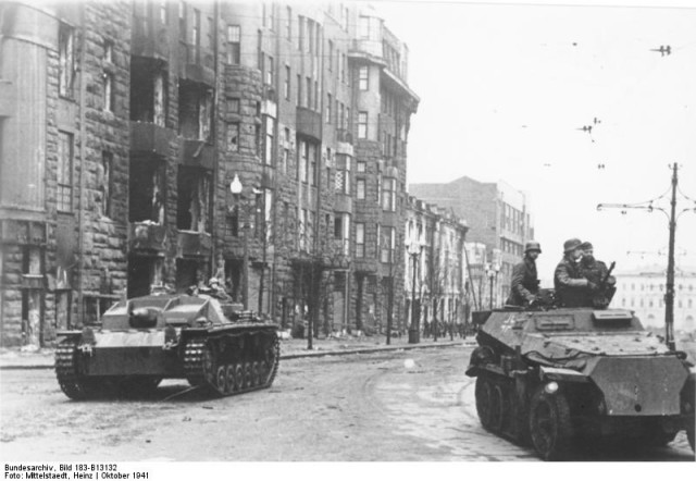 German assault gun Sturmgeshutz III and light armoured halftrack Sd.Kfz.250 on streets in Charkov. October 1941