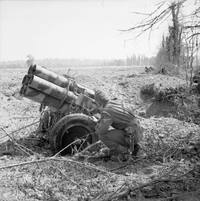A British soldier examines an abandoned German 'Nebelwerfer' near Troarn, Normandy, 20 July 1944. They were feared by all Allied troops in Normandy and caused a high proportion of casualties (© IWM (B 7785))