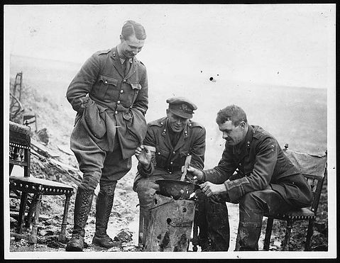 'Open air cookery in a steel helmet near Miraumont-le-Grand.'