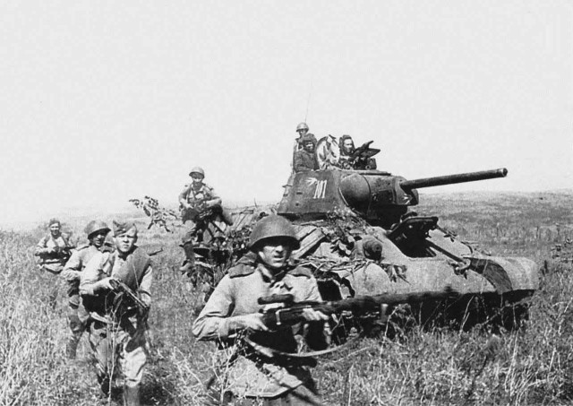 Soviet infantry advance alongside T-34 tanks. Summer 1944.