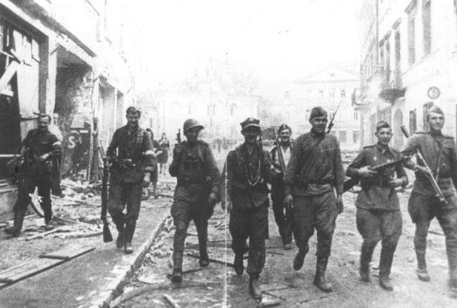Battle of Vilnius. Soviet and Polish Armia Krajowa Soldiers patrolling along the Large Street. The orthodox church of Vilnius is visible in the background. 16 July 1944.