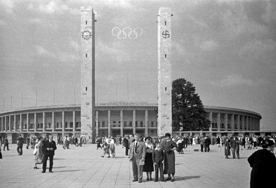Columbus outside of the Olympic Stadium prominently displaying the Swastika 
