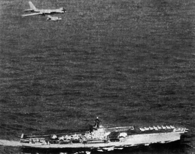 A TU-95RTs of the 392nd ODRAP, escorted by an F-4 Phantom from VF-31, overflies the “USS Saratoga” (CV-60) 