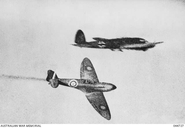 A Spitfire aircraft going down after being hit by a German Heinkel III in a dog fight. [© AWM 044727]