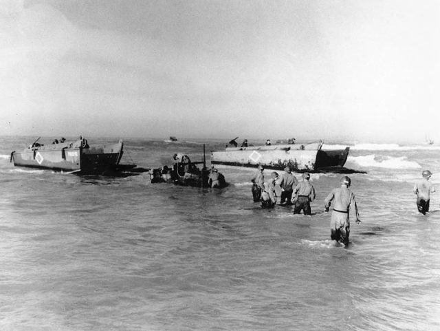 U.S. Navy LCVPs from USS Joseph T. Dickman (APA-13) landing vehicles through the surf at Gela, Sicily, on 10-12 July 1943. The truck in the center appears to have stalled. [U.S. Navy photo 26-G-1788 from the U.S. Navy Naval History and Heritage Command]
