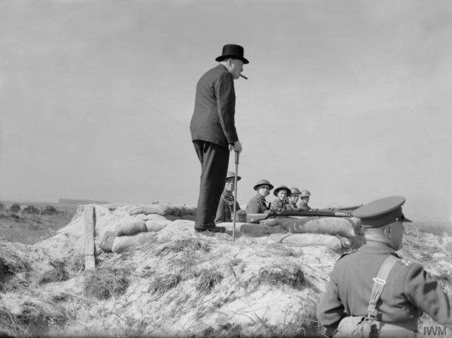 The Prime Minister Winston Churchill meets infantrymen manning a coast defence position near Hartlepool on 31 July 1940. [© IWM (H 2628)]