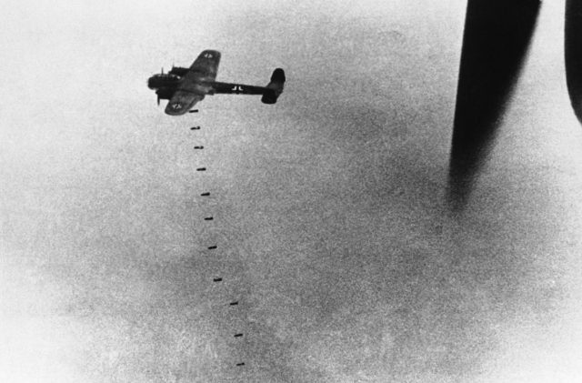 A Dornier Do-17 medium bomber dropping a string of bombs on London, England, United Kingdom. 20 September 1940. [Public Domain]