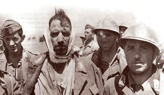 Italian soldiers of the 206th Coastal Division, taken prisoner by British forces after the landing in Sicily. Typical of the second-rate equipment issued to the Coastal Divisions, they are wearing Adrian helmets, rather than the more modern M33 helmets. [Public Domain]